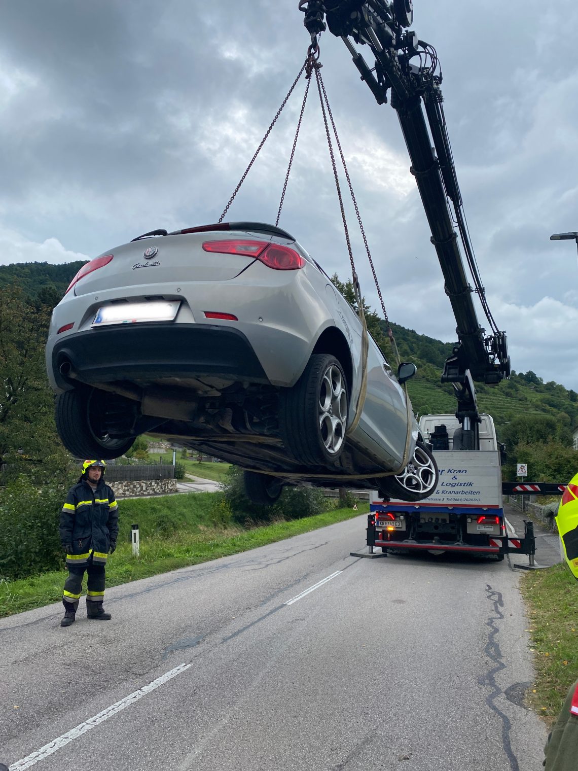 PKW der von Kran hochgehoben wird.